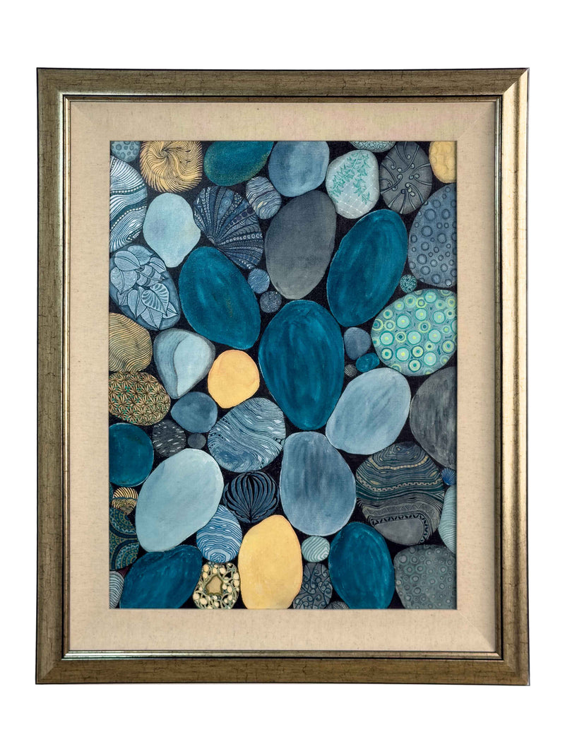 Framed painting of hand-painted pebble shapes in shades of deep blue, teal and soft yellow, each with a distinct textured pattern, on natural linen in a silver-gold frame — Tangled Monk original hand-drawn art