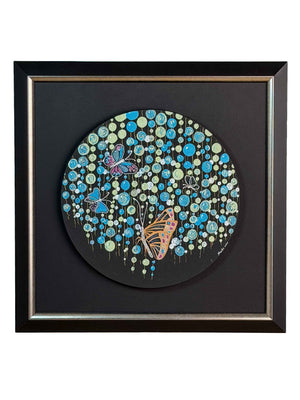 Framed circular artwork of turquoise, sage and white dots on black canvas with two butterflies drifting through them, on a black mount in a black and silver wooden frame — Tangled Monk original hand-drawn art
