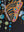 Close-up of a large copper-winged butterfly with magenta and blue panels beside falling strings of blue dots — Tangled Monk original hand-drawn art